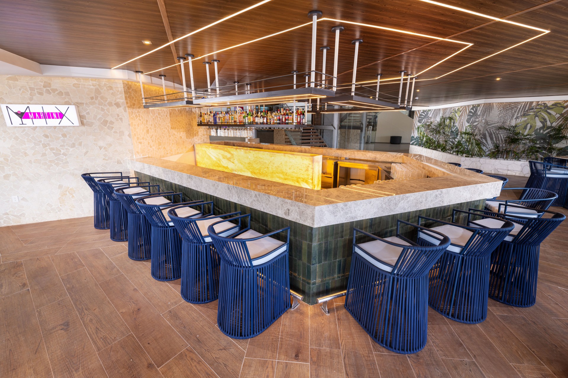 a bar with blue chairs and a counter