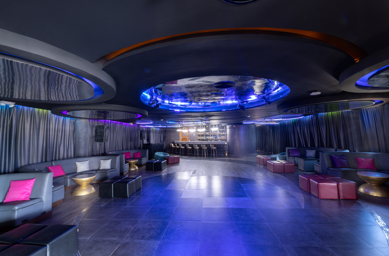 a room with colorful seats and a bar