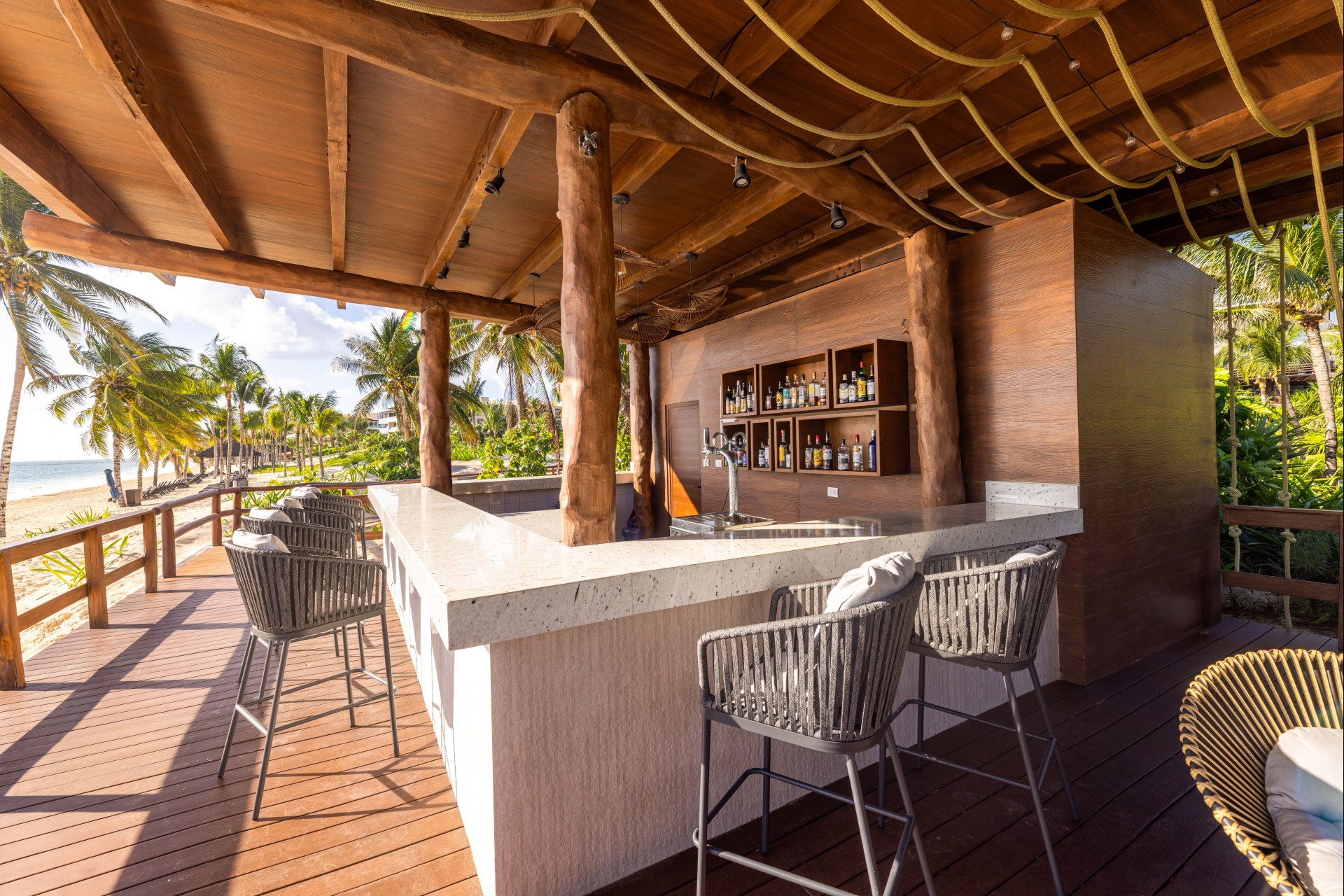 a bar with chairs and a bar on a deck