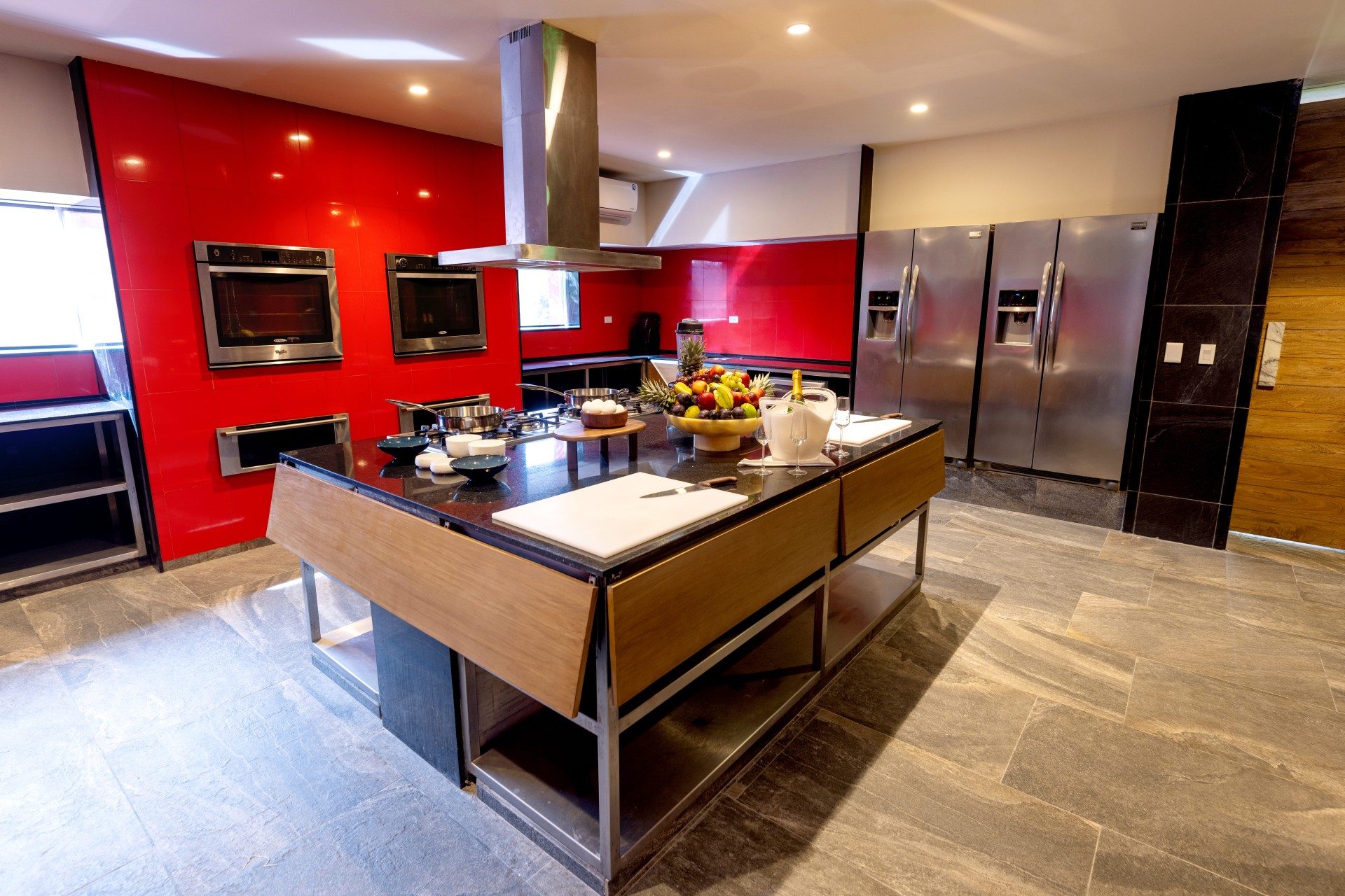 a kitchen with a large island and stainless steel appliances