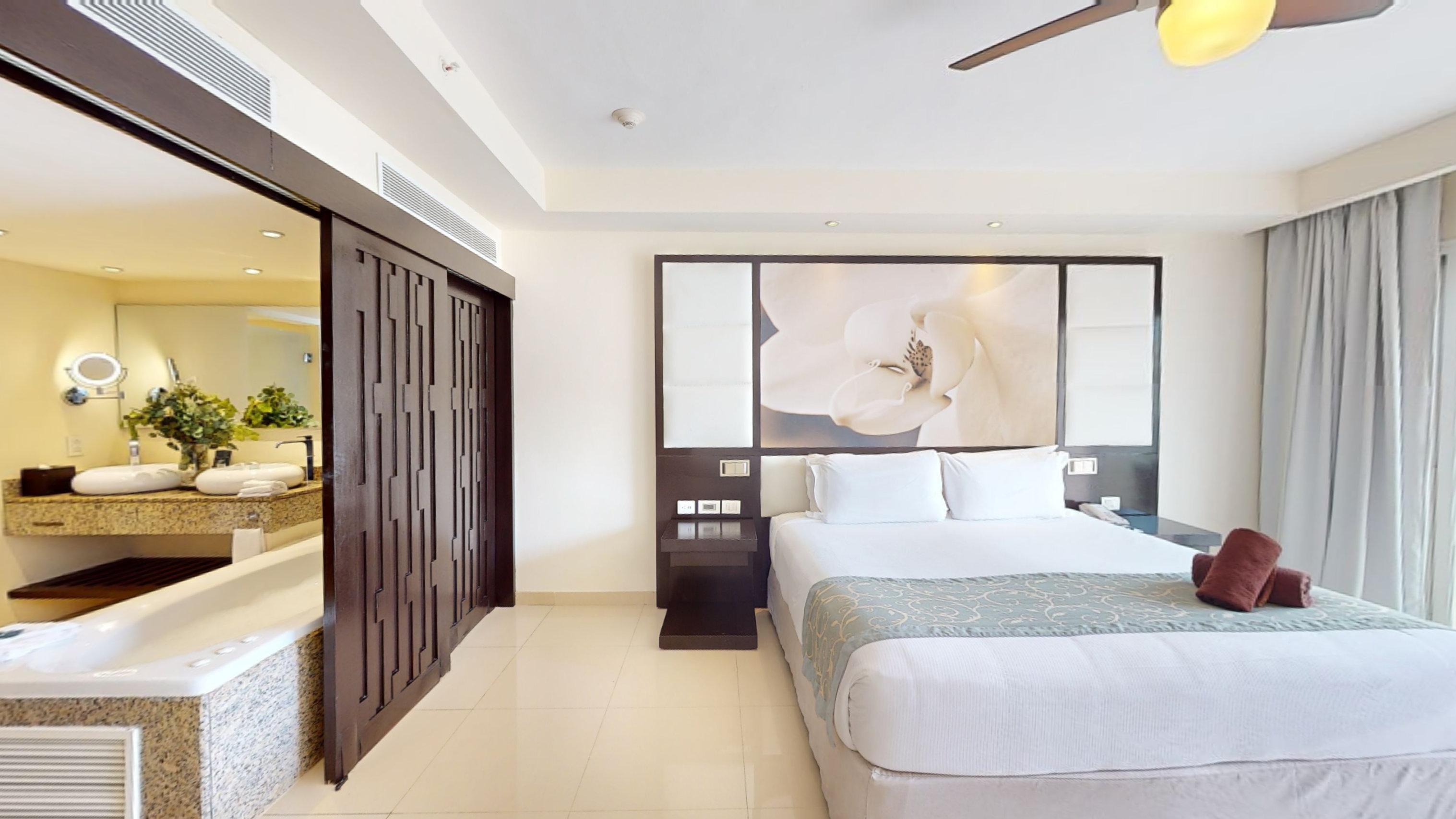 a room with a bed and a fan