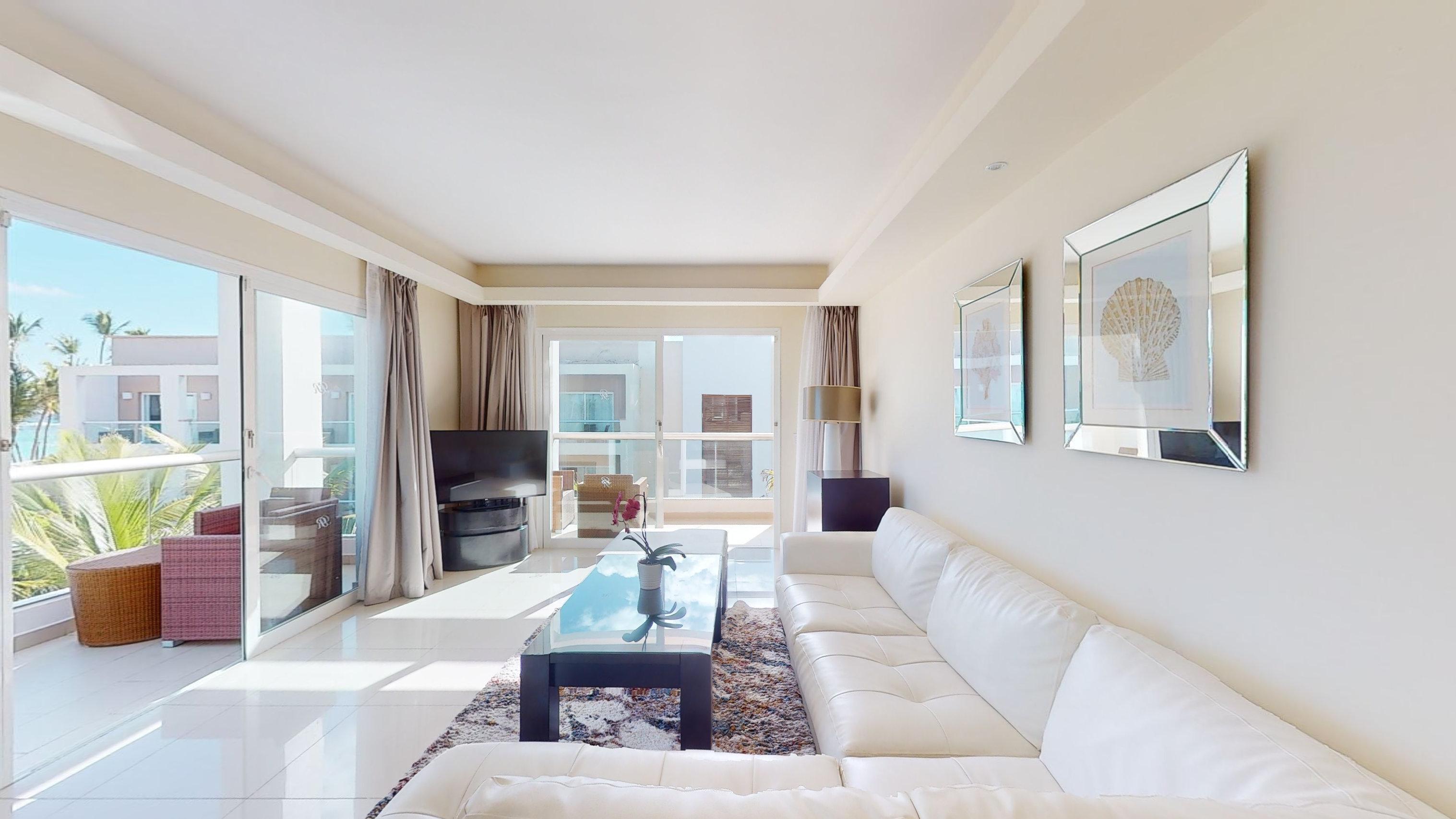 a living room with white couches and a coffee table
