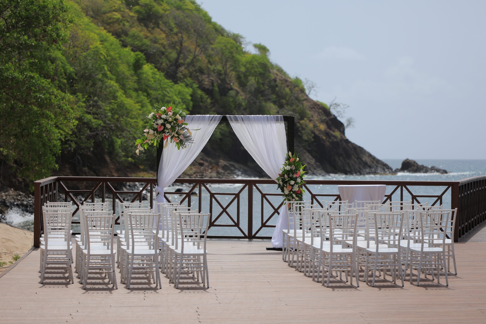 a wedding set up with chairs and flowers