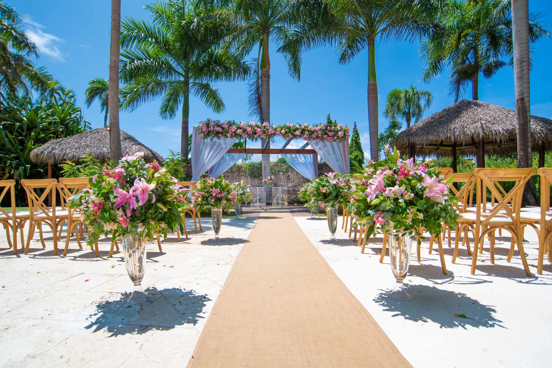 a wedding ceremony with chairs and flowers