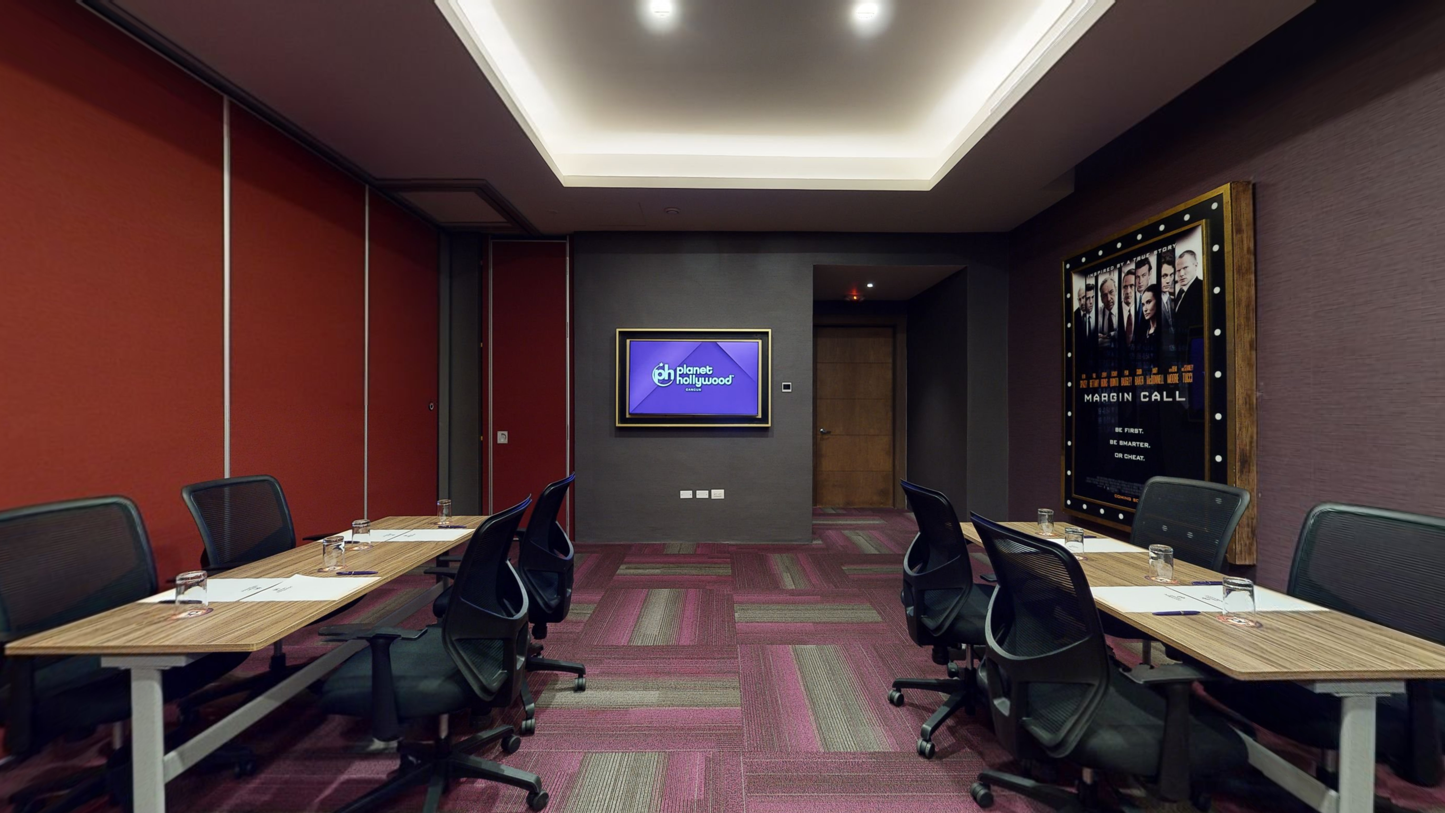 a room with chairs and a screen