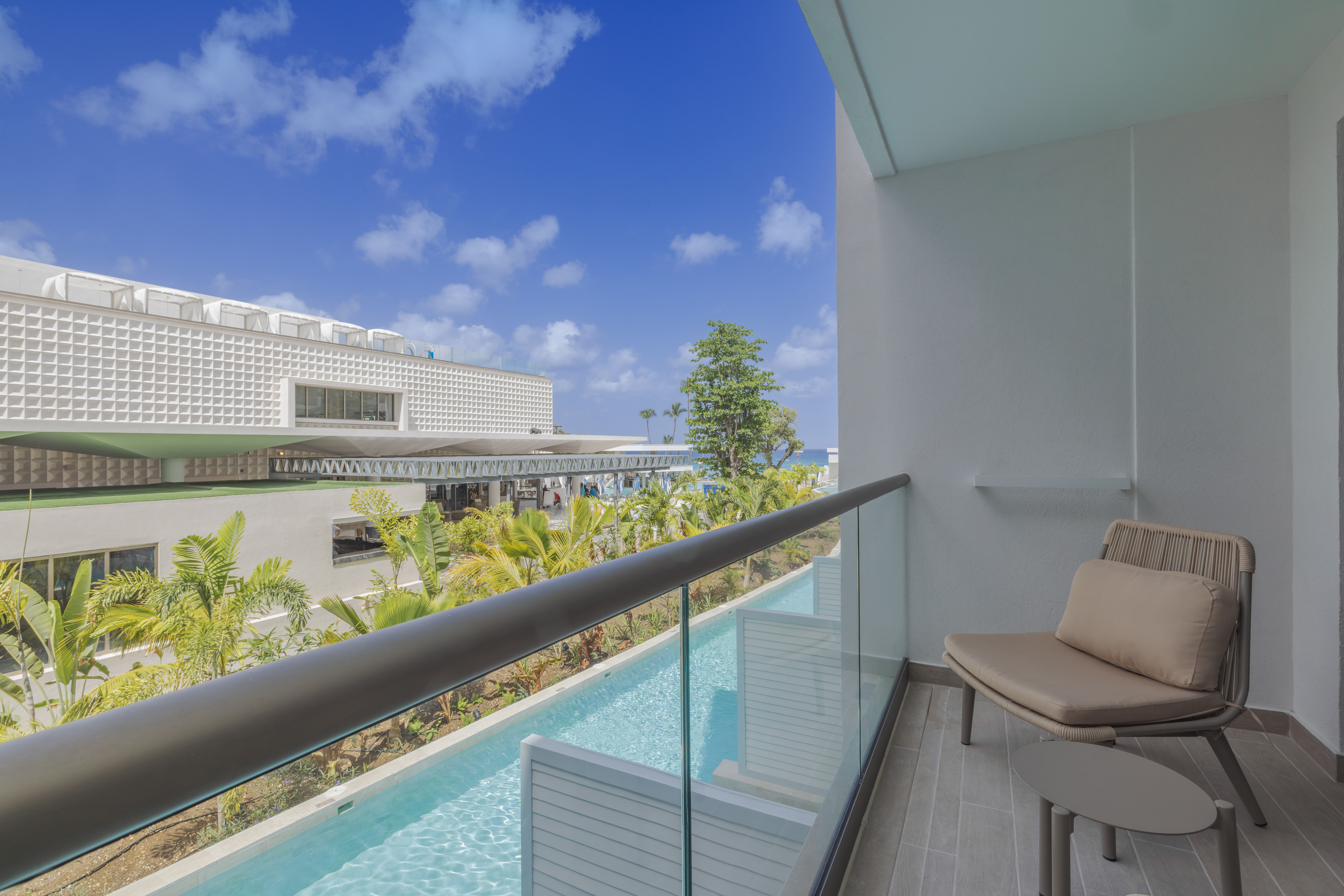 a balcony with a pool and chairs