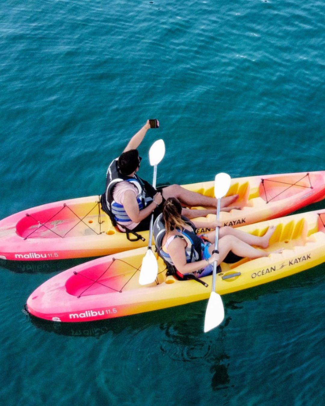 a couple of people in kayaks on the water