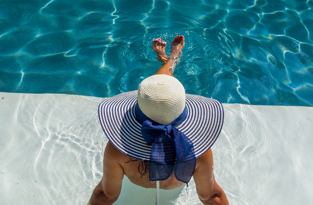 a woman in a hat in a pool