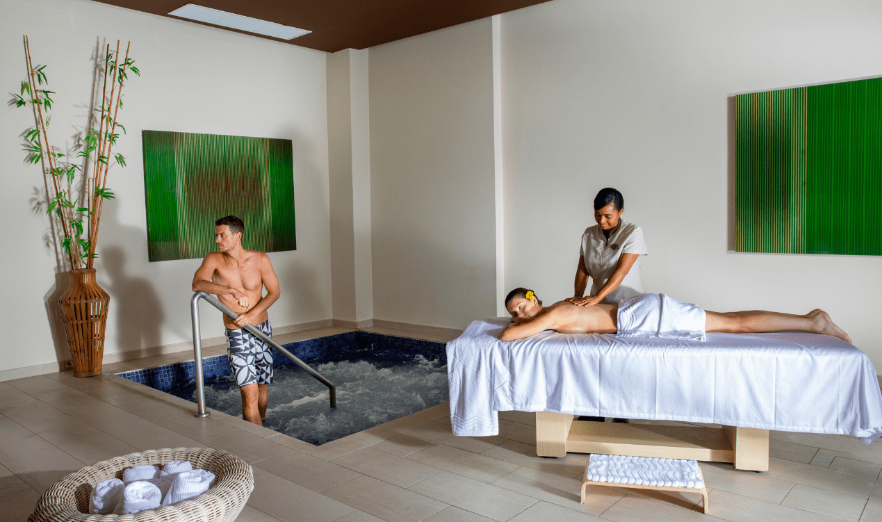 a woman getting a massage from a man in a hot tub