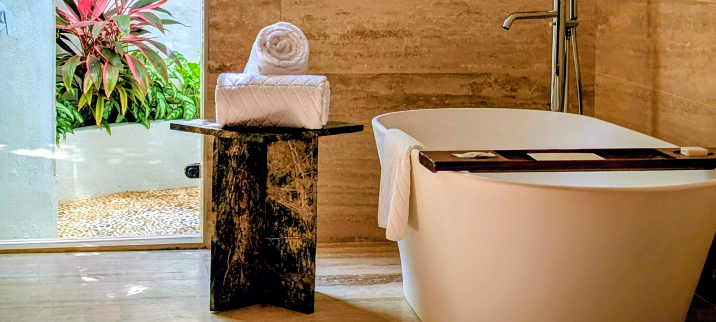 a bathtub and towels on a table