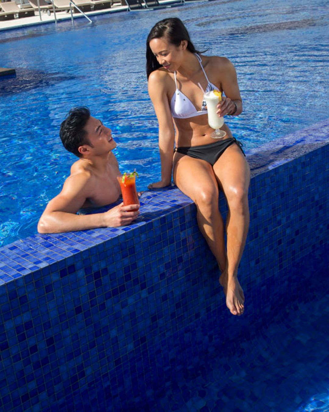 a man and woman in a pool