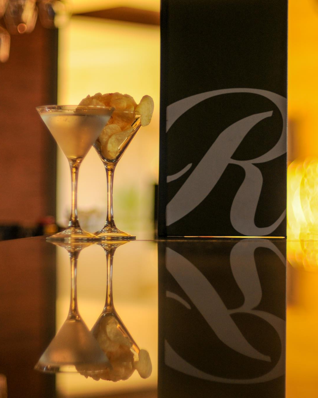 two glasses of drinks on a table