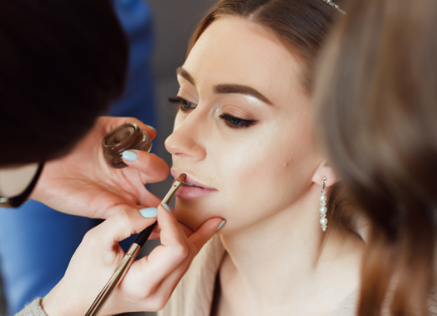a woman getting her makeup done