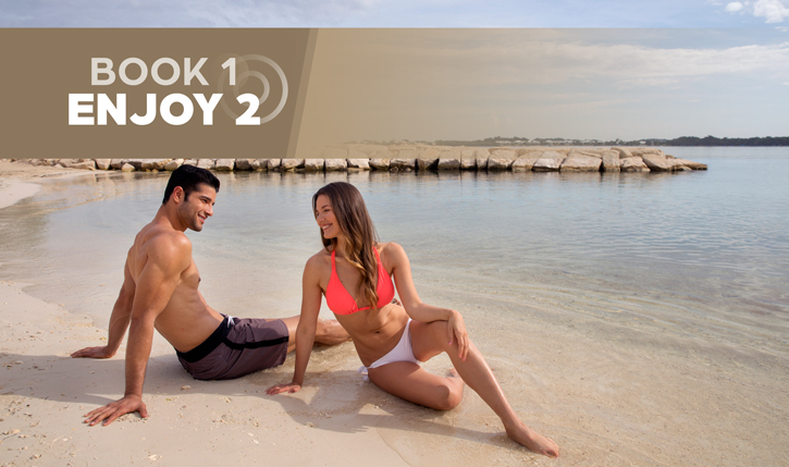 a man and woman sitting on a beach