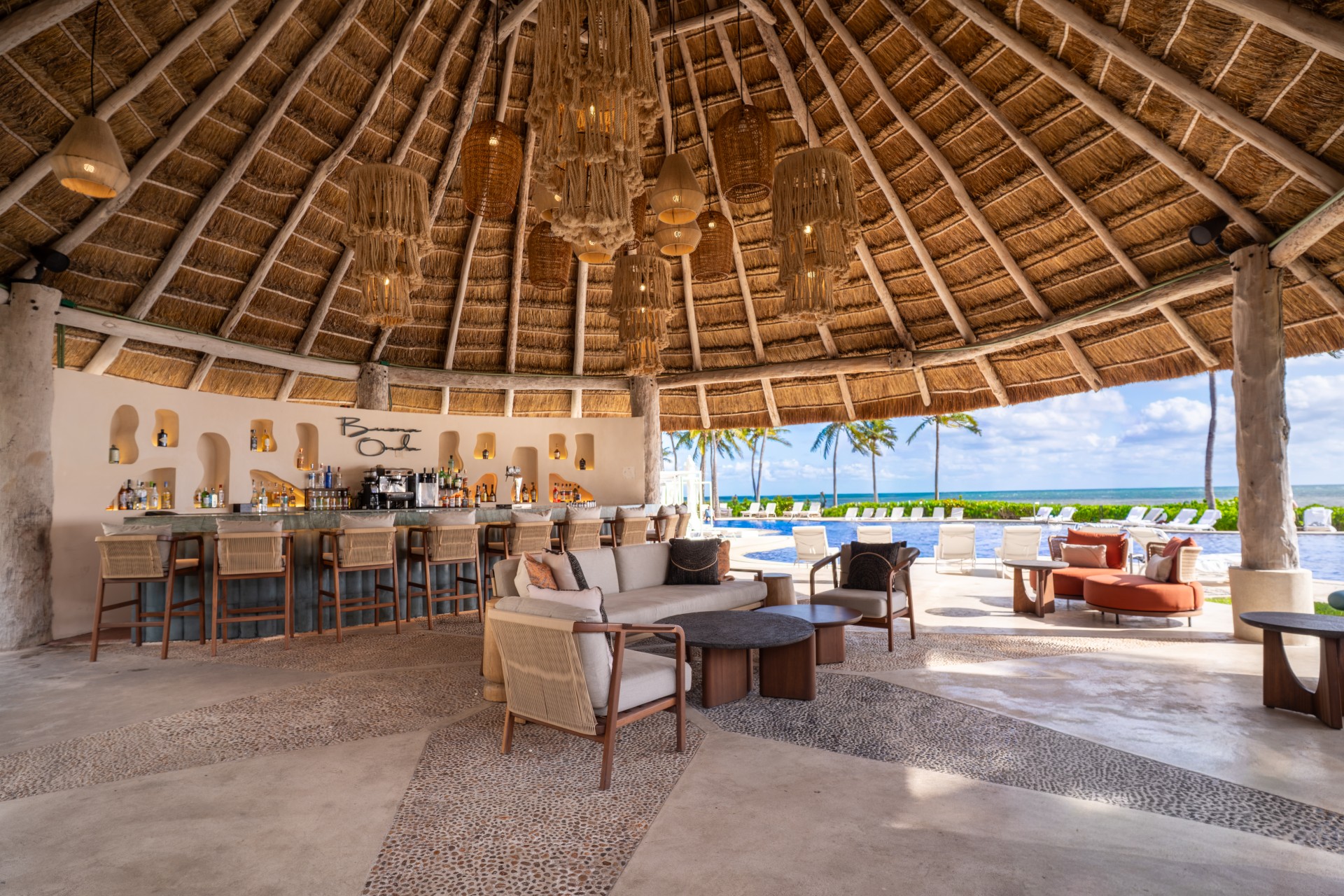 a lounge area with a bar and chairs