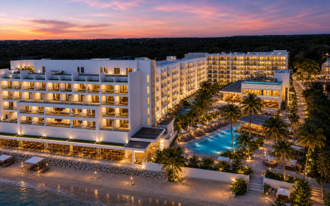 a hotel with a pool and palm trees