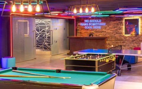 a pool table in a room with neon lights
