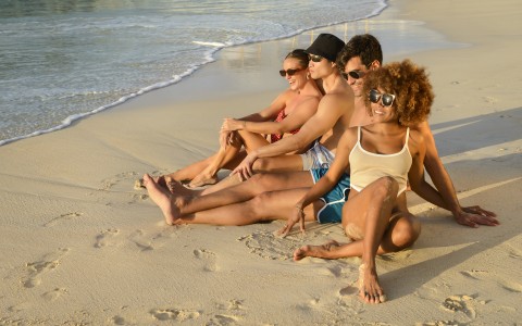 a group of people sitting on a beach