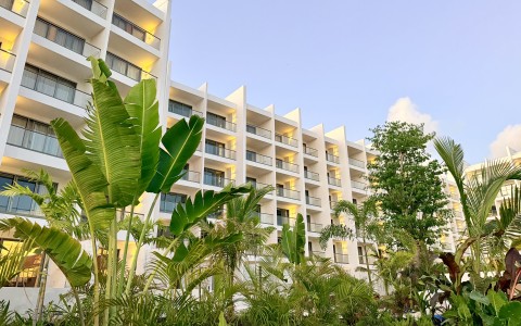a building with many balconies and plants