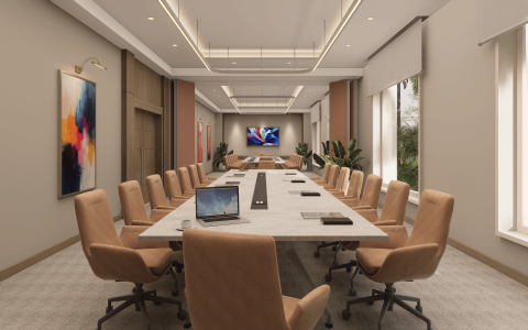 a conference room with a laptop on the table
