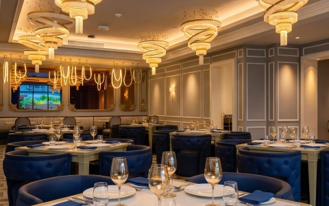 a restaurant with chandeliers and tables
