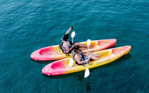a couple of people in kayaks on the water