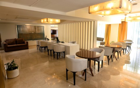 a room with white chairs and tables