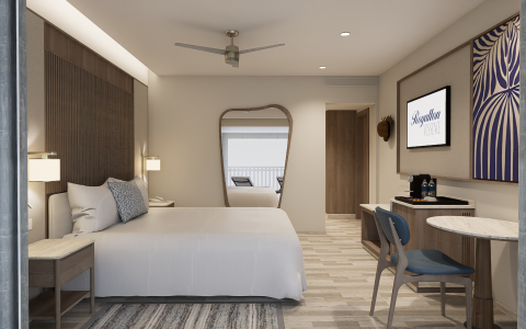 a room with a bed and a desk and a mirror