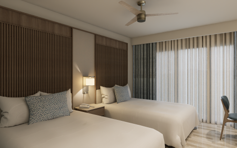 a room with two beds and a fan