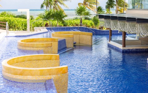 a pool with a jacuzzi and a gazebo