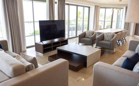 a living room with a television and chairs