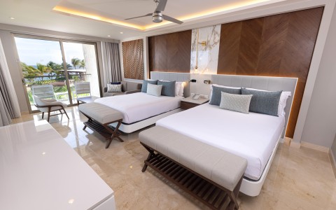 a room with two beds and a ceiling fan