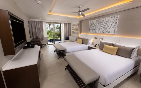 a room with two beds and a television