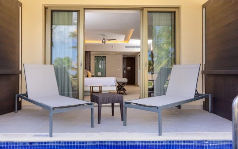 chairs next to a pool