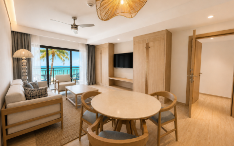 a room with a table and chairs and a television