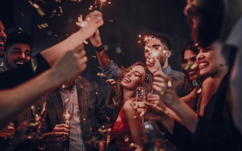 a group of people holding champagne glasses