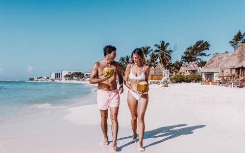 a man and woman walking on a beach