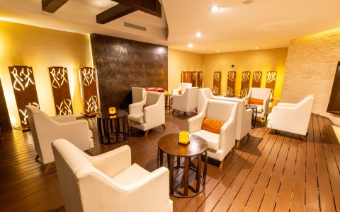 a room with white chairs and tables