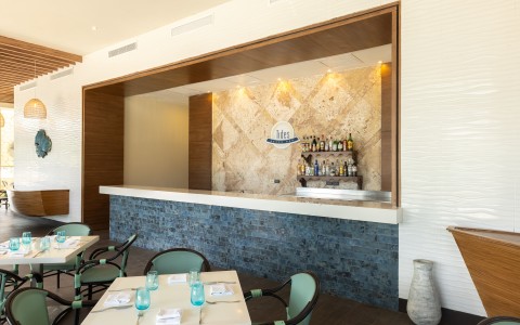 a bar with a counter and chairs