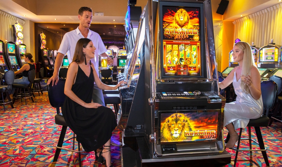 a man and woman playing slot machines