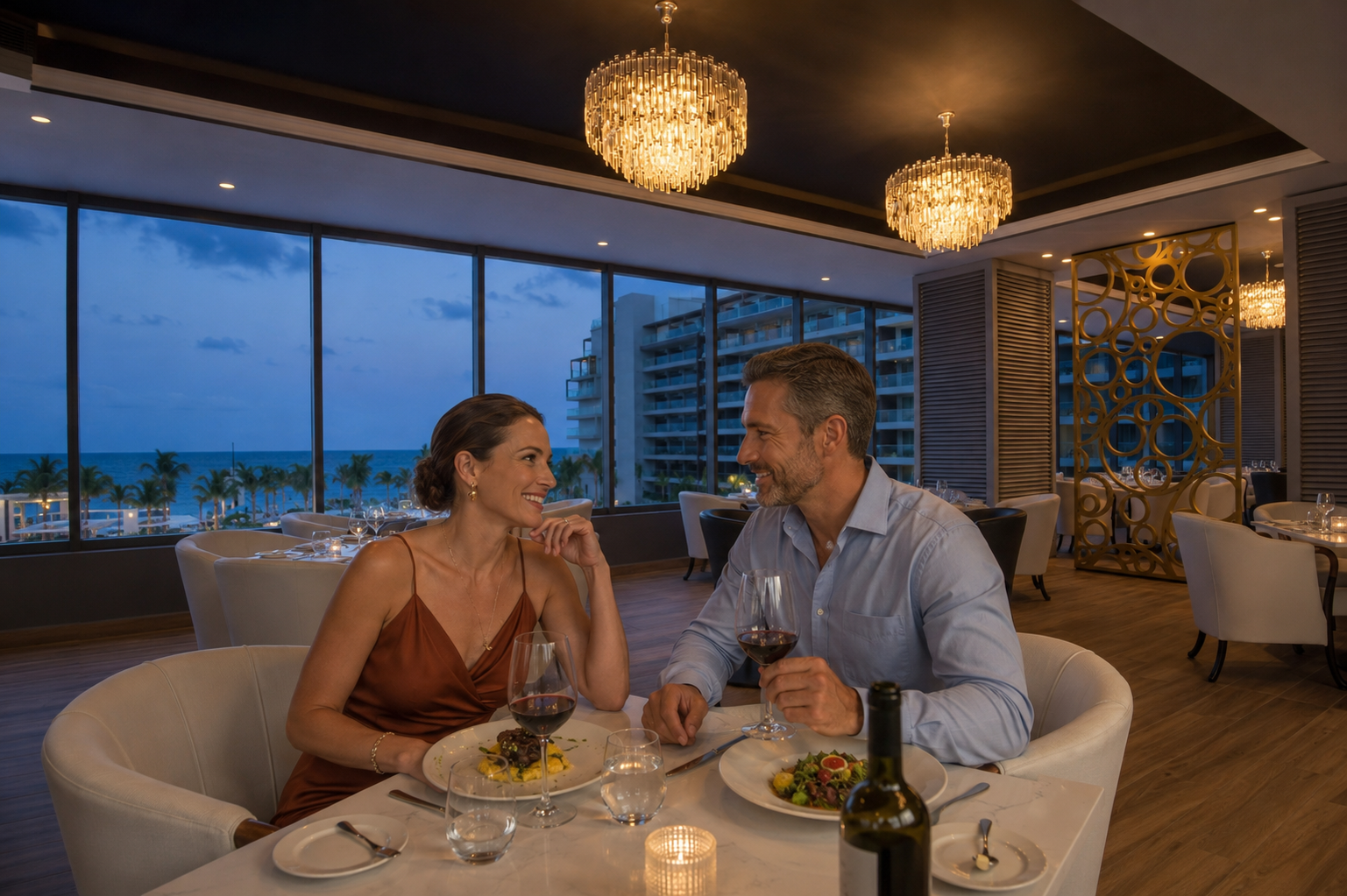 a man and woman sitting at a table with food and wine