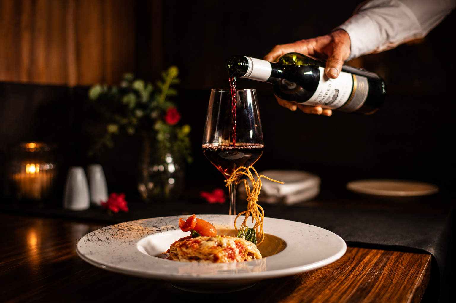Wine being poured over dinner