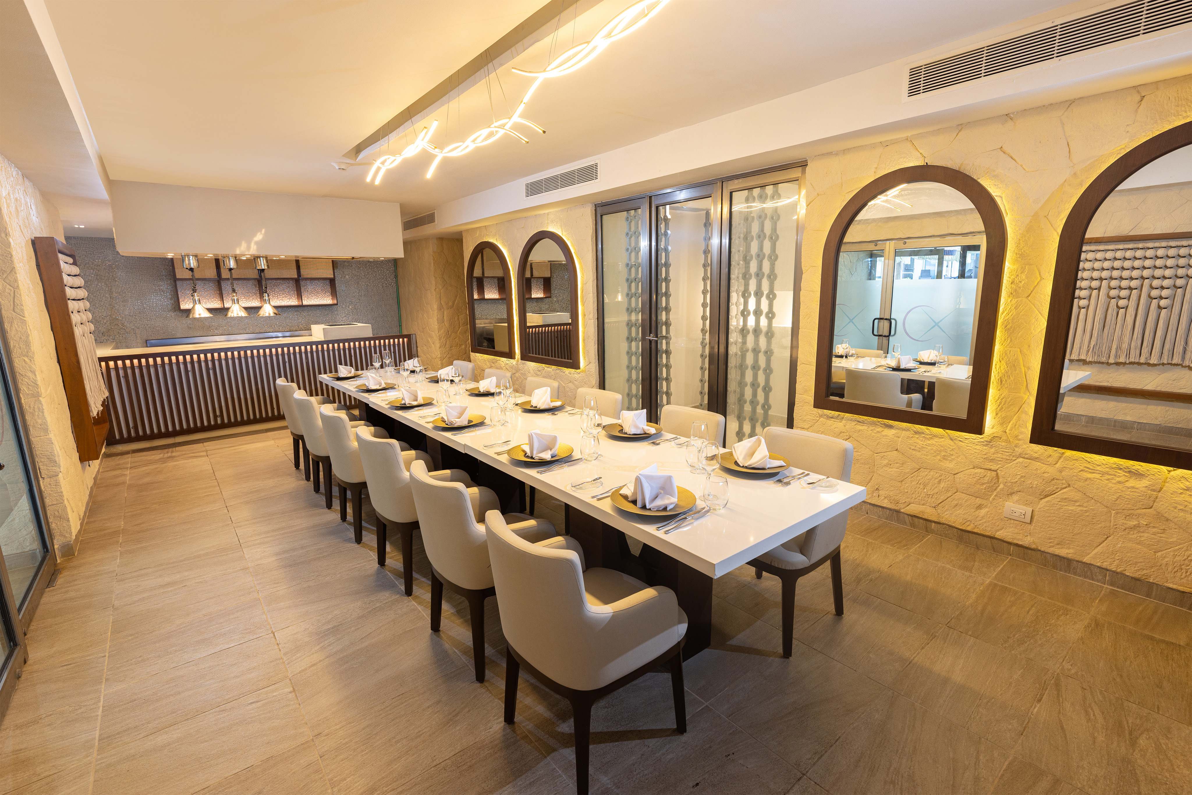 a long table with chairs and plates in a room