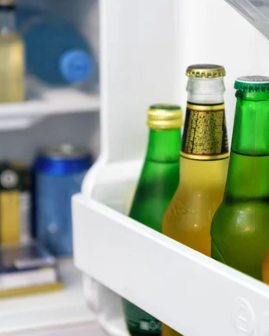 a group of bottles in a refrigerator