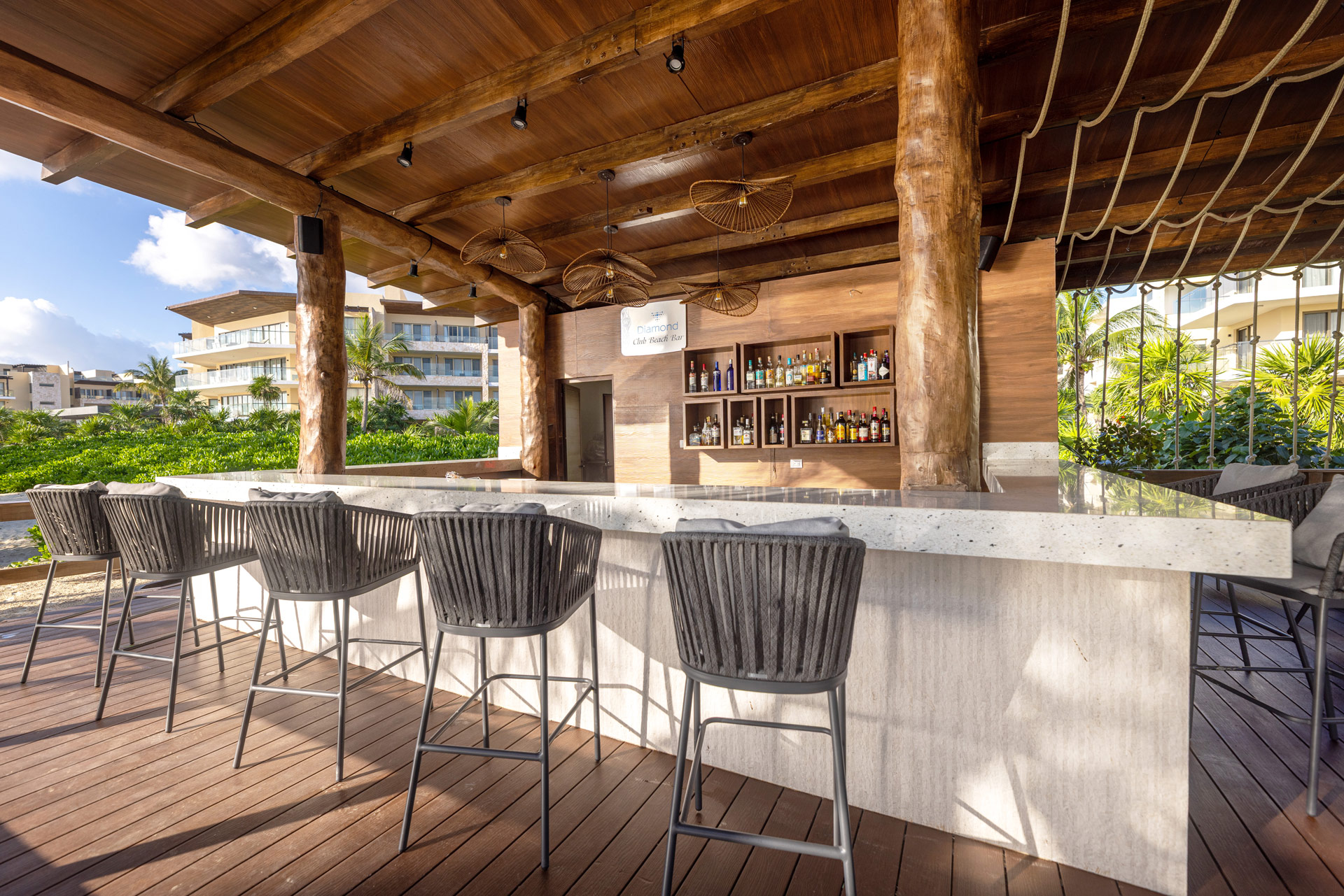 a bar with chairs and a wood covered area