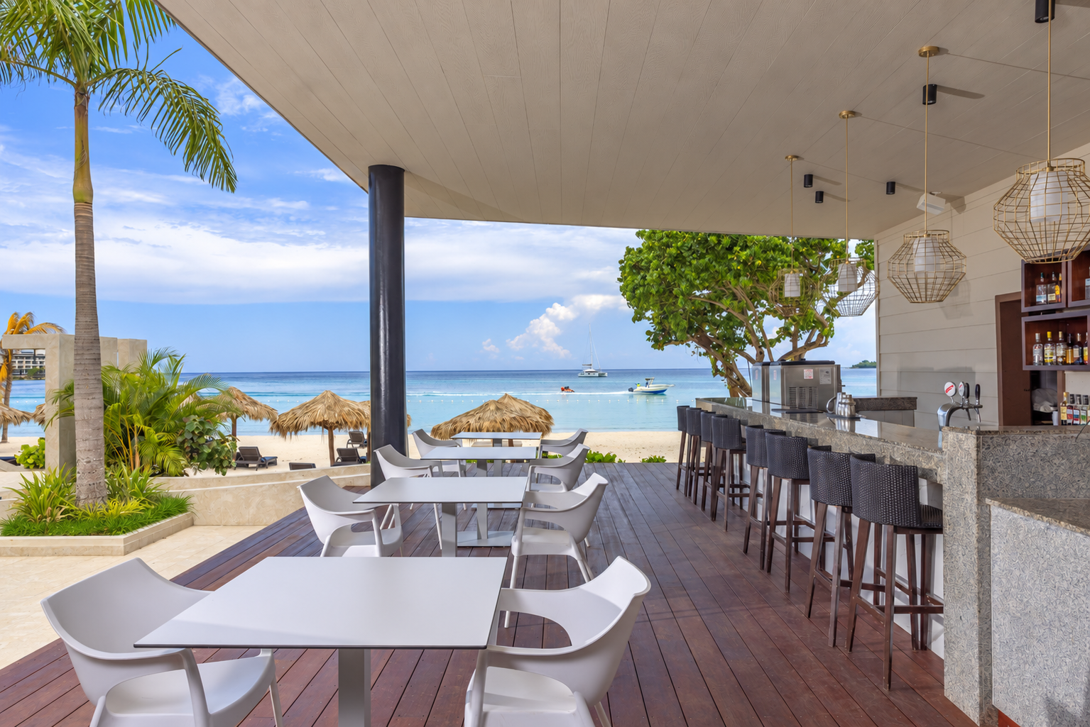 a beach bar with tables and chairs