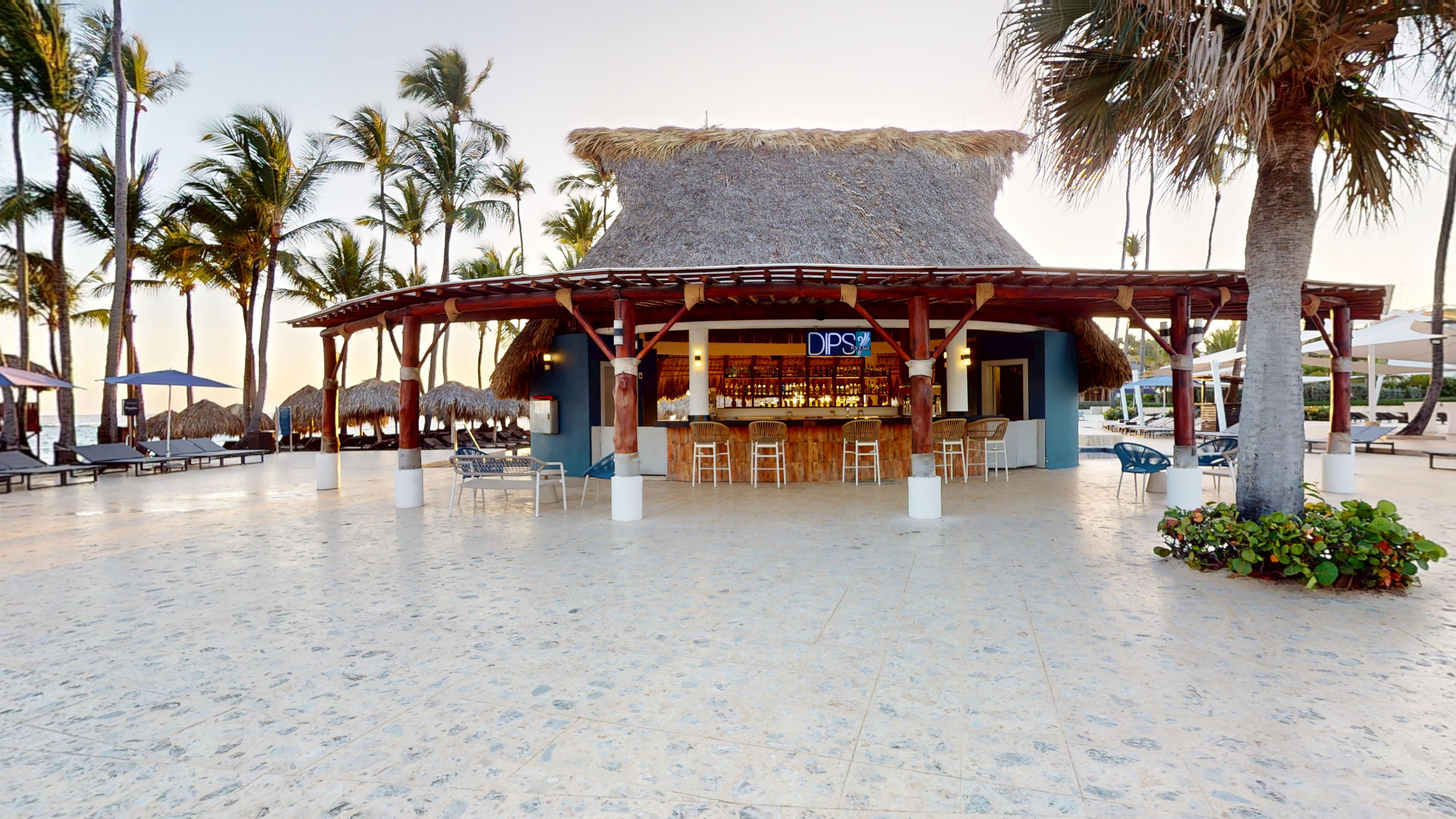 a bar with chairs and tables in front of it