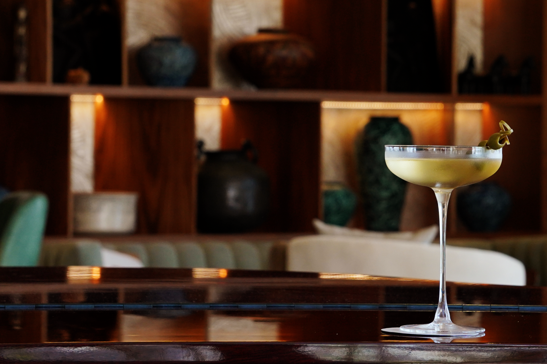 a glass of liquid on a bar