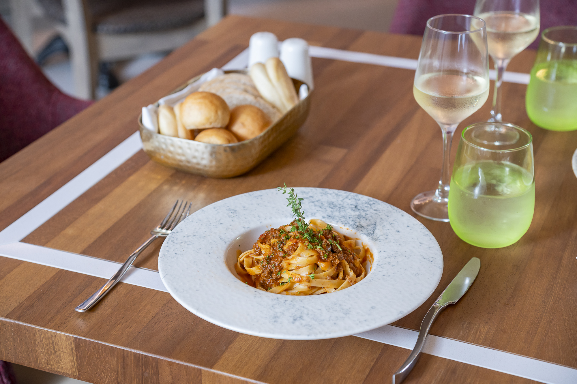 a plate of pasta and bread on a table