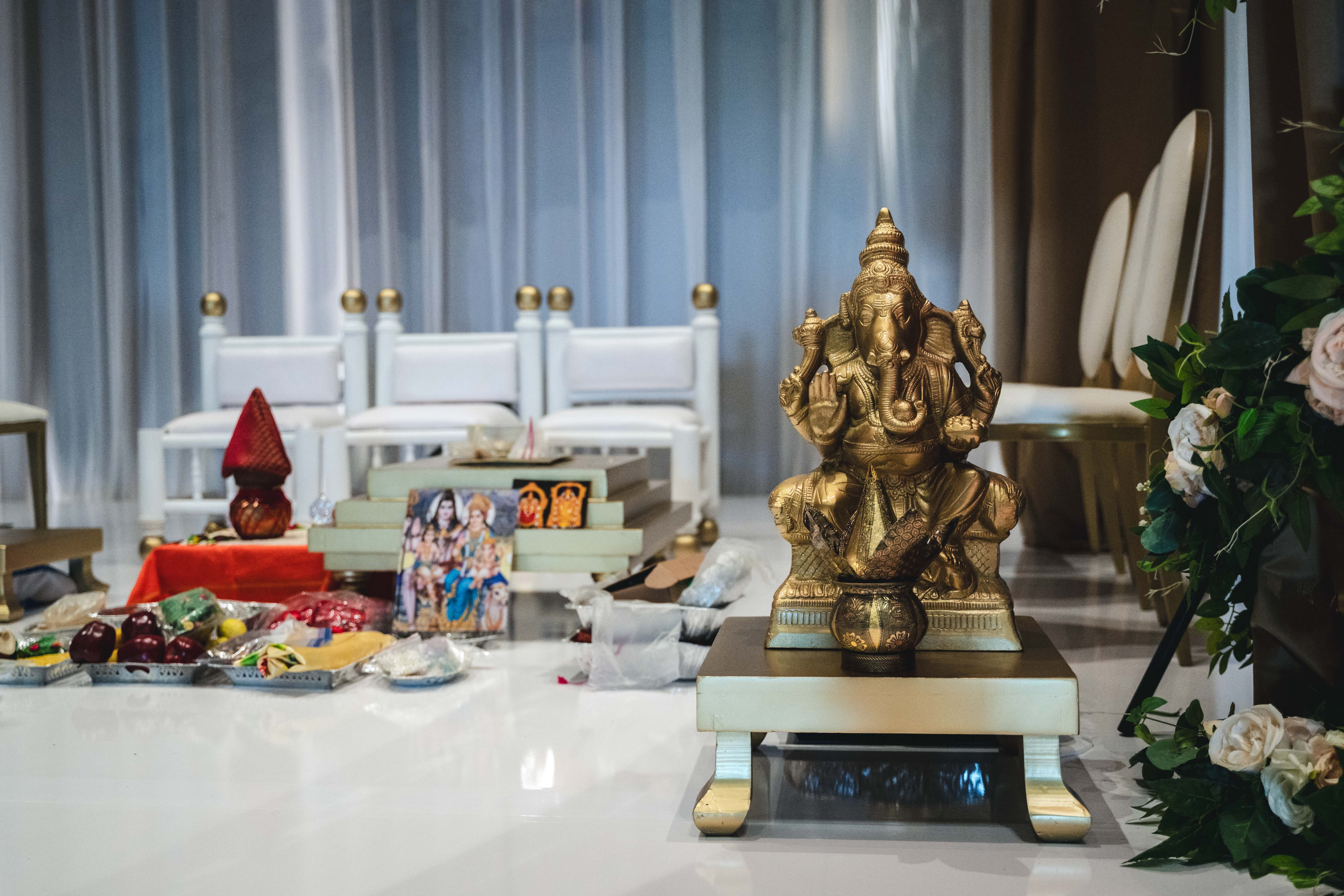 a gold statue of an elephant on a white floor